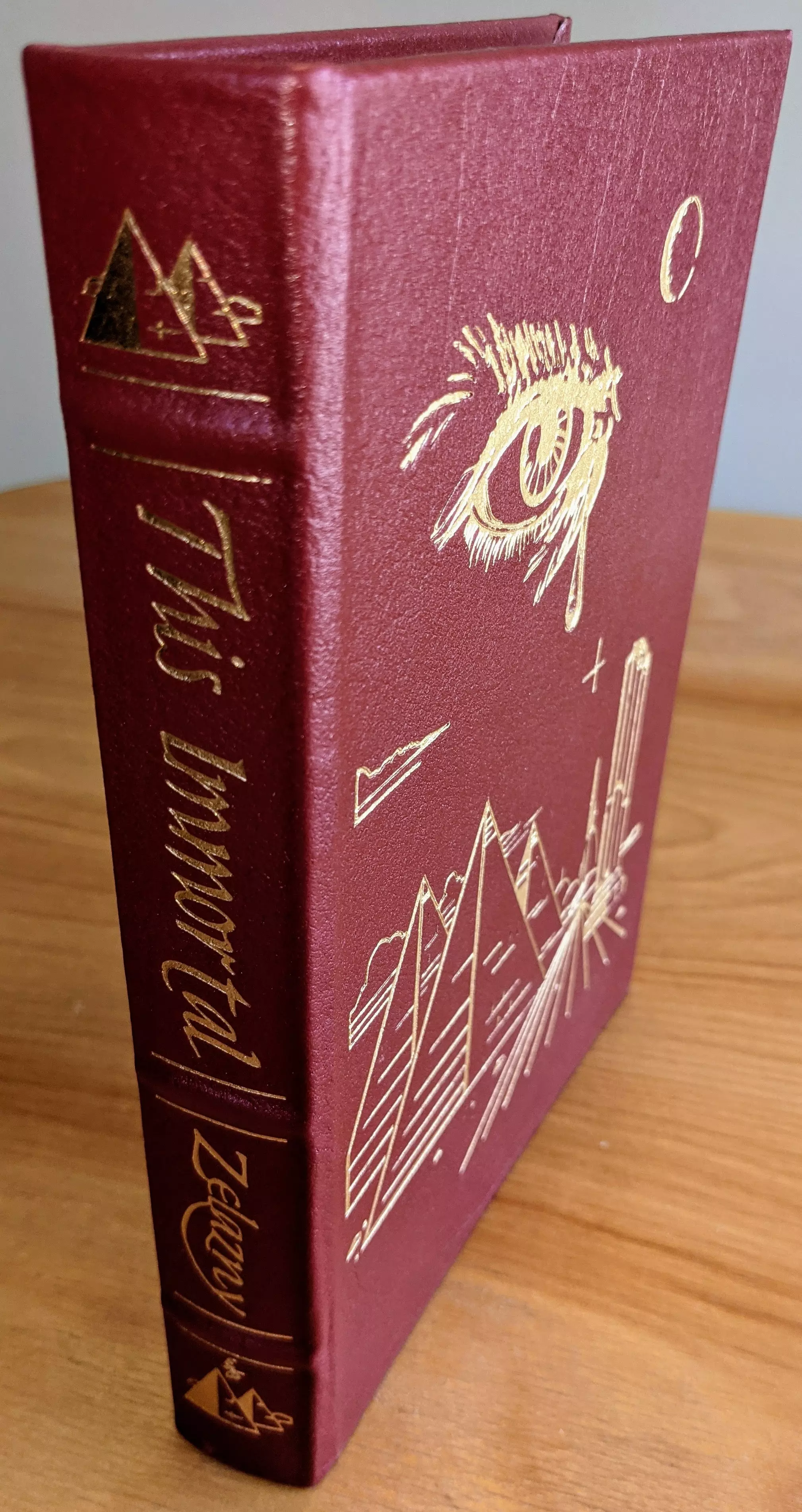 Stunning Red Leather Bound hardback book with hubbed spine, cover artwork in 22kt gold, printed on archival paper with gold gilded edges, smyth sewing & concealed muslin joints
	  - original artwork by Vincent DiFate