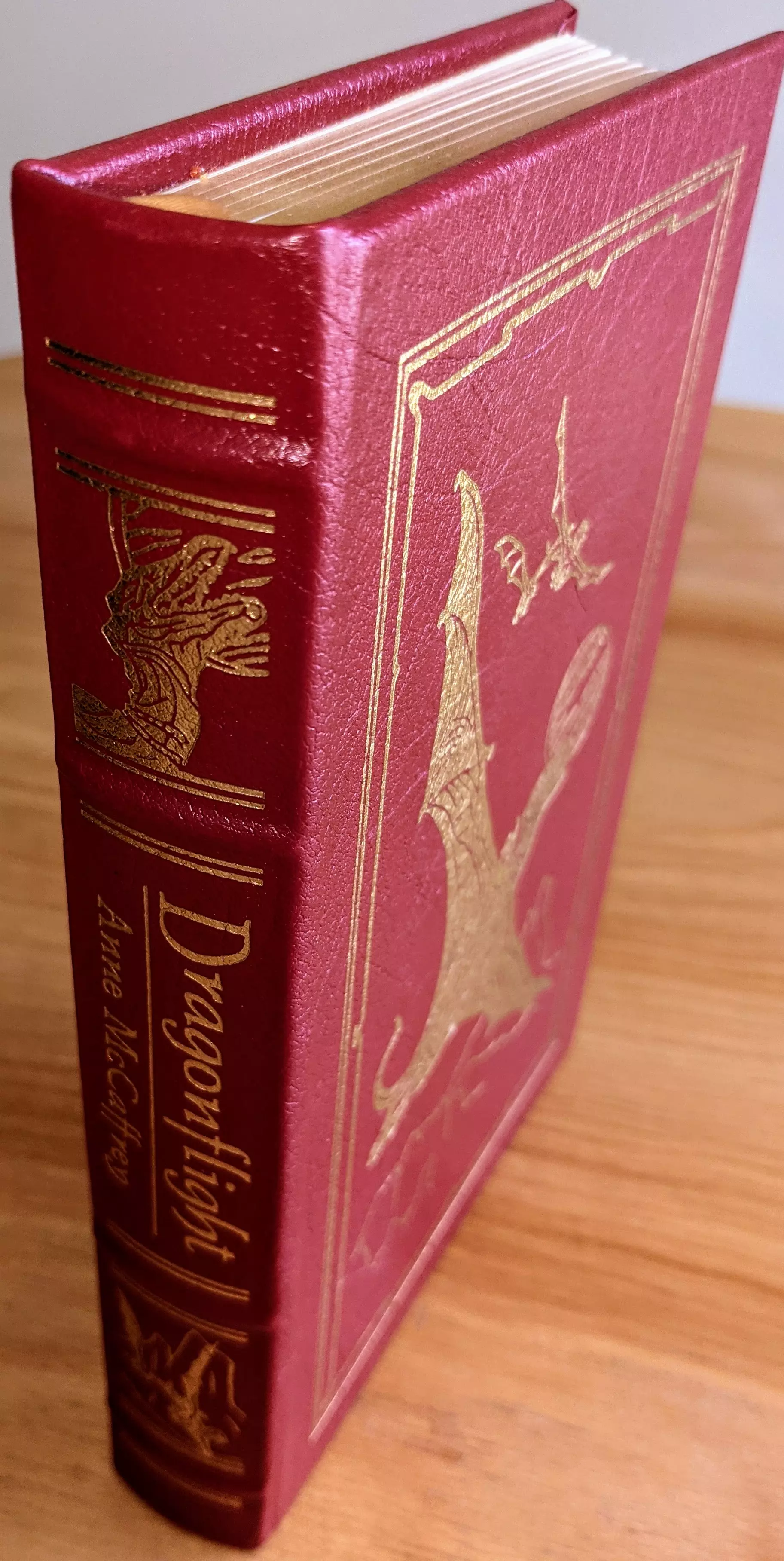 Stunning Red Leather Bound hardback book with hubbed spine, cover artwork in 22kt gold, printed on archival paper with gold gilded edges, smyth sewing & concealed muslin joints
	  - original artwork by Michael Whelan