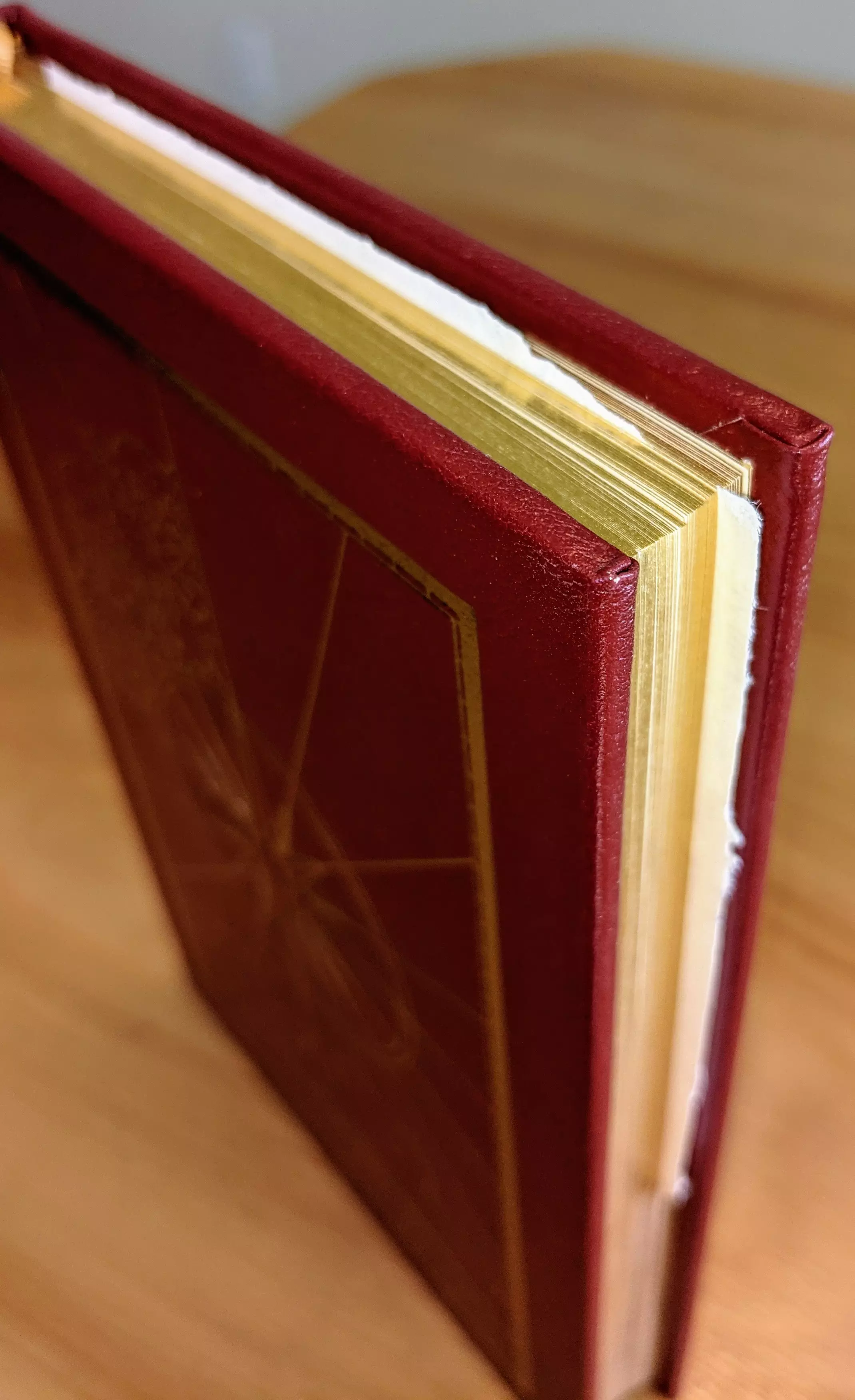 Stunning Red Leather Bound hardback book with hubbed spine, cover artwork in 22kt gold, printed on archival paper with gold gilded edges, smyth sewing & concealed muslin joints
	  - original artwork by Jeff Fisher